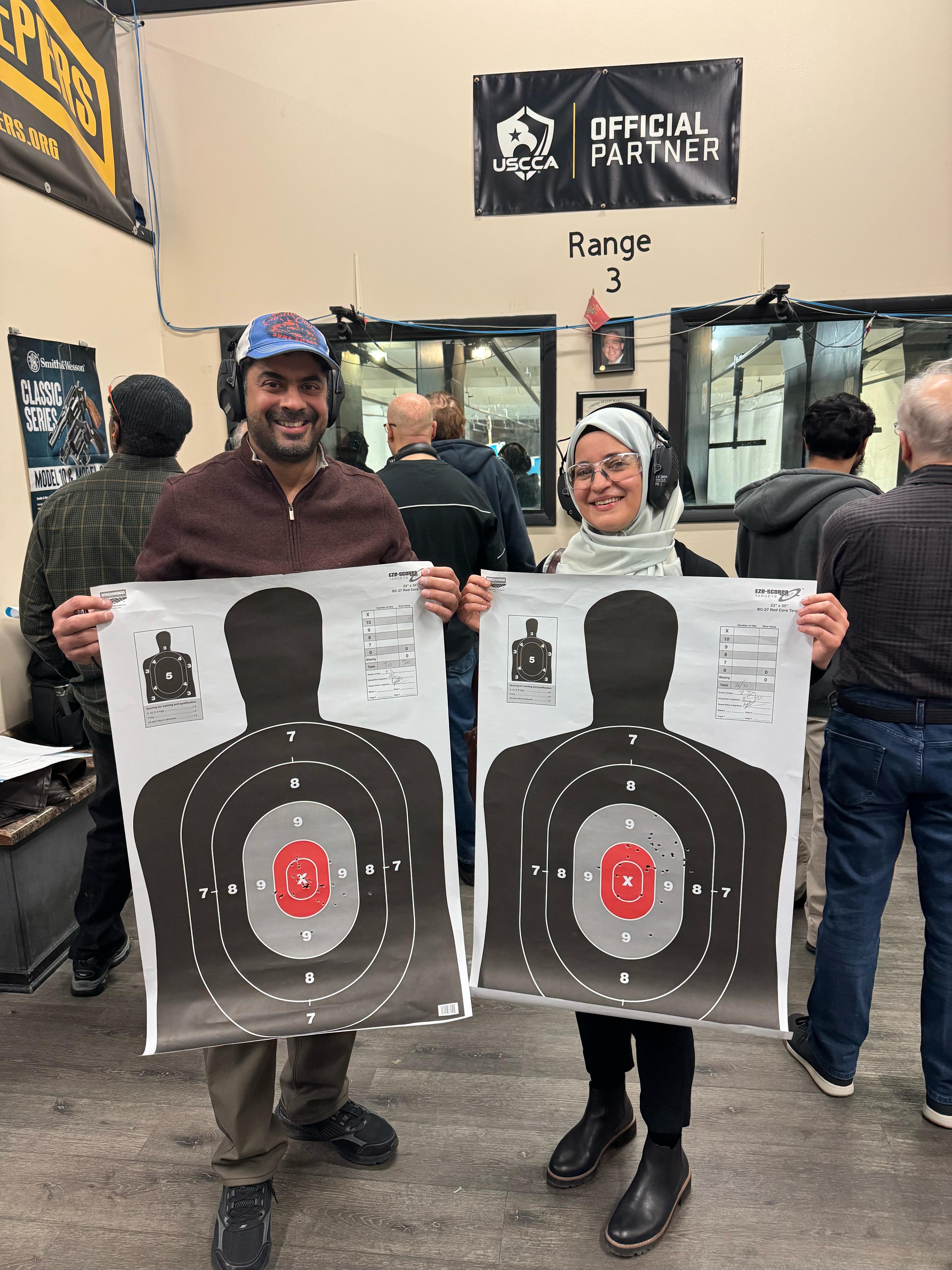 Students holding targets after range training